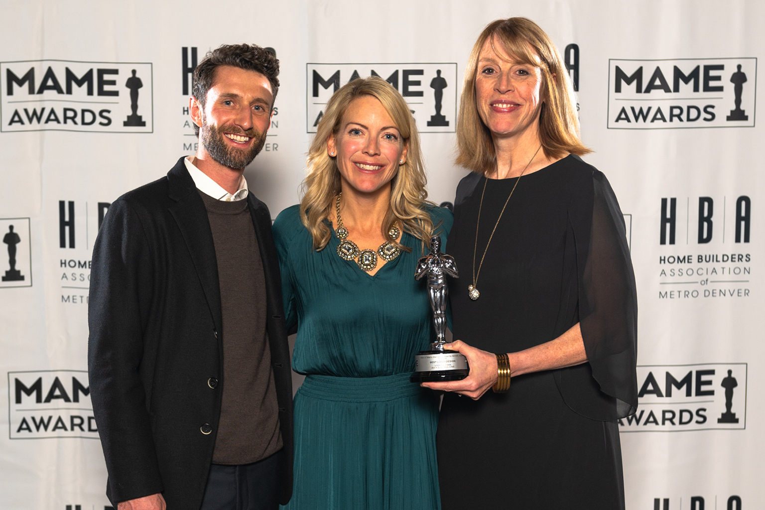 Ethan Demby, Jessica Davis, and Cindy Milnick accepting awards at previous Denver MAME Awards ceremony.